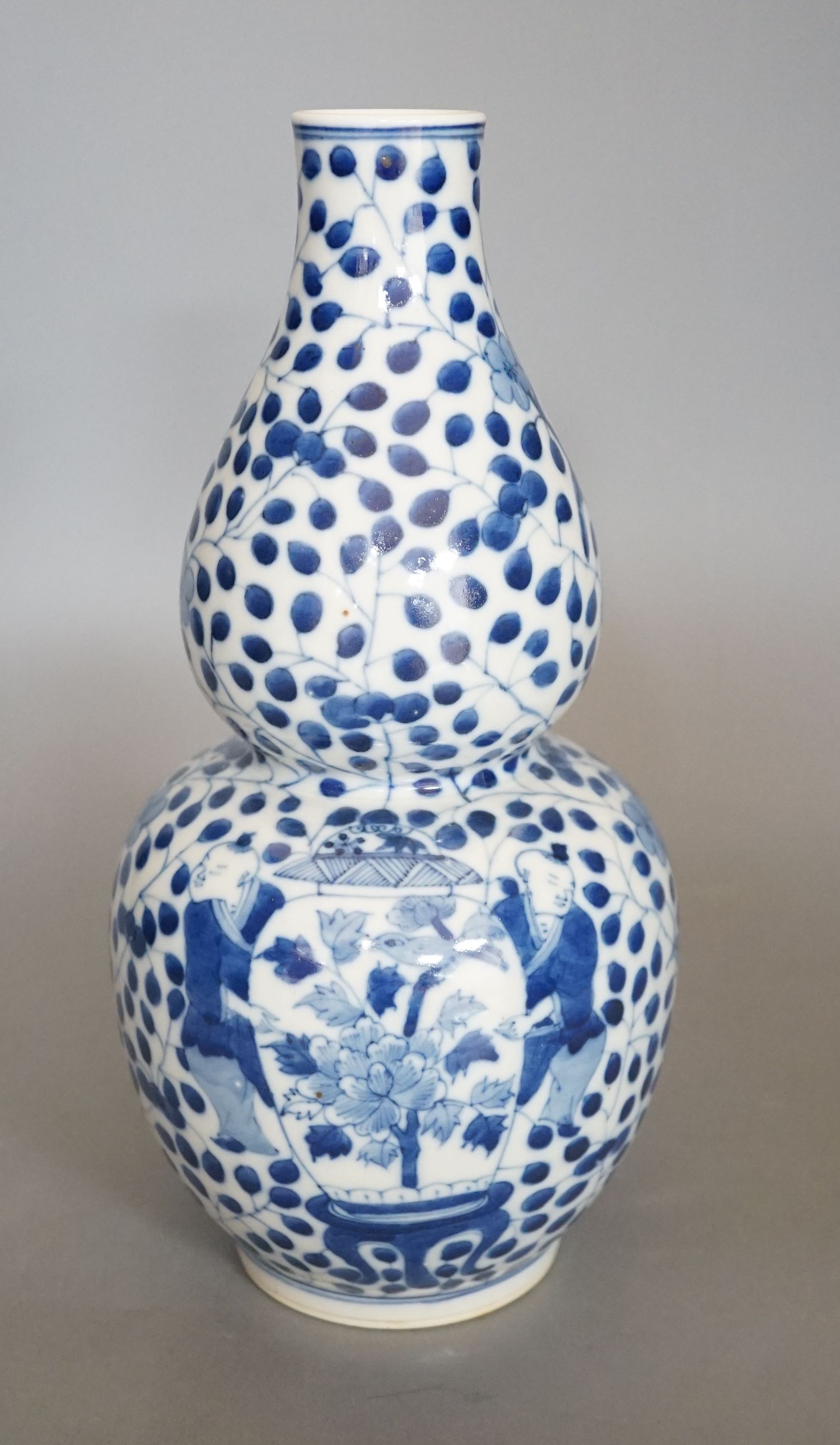 A Chinese double gourd blue and white vase, 27 cms high.